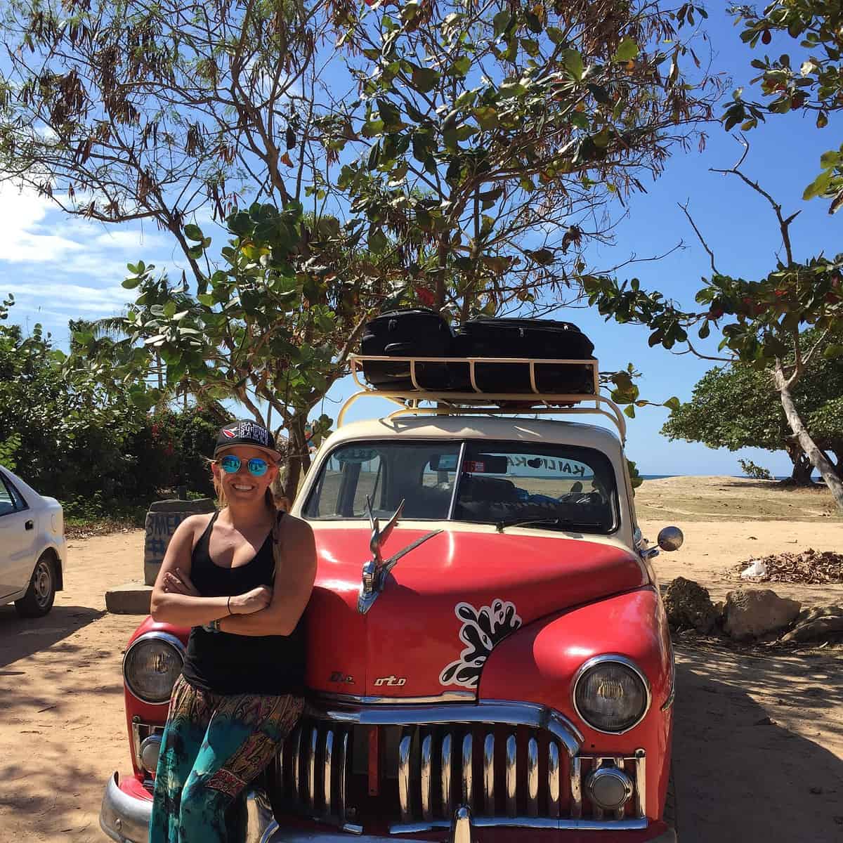 Me standing in front of a car in Cuba