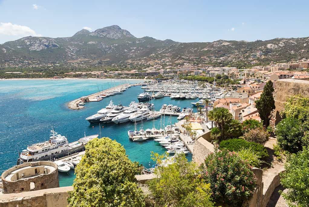 Super Yachts docked in the marina in Corsica, France with tropical blue waters